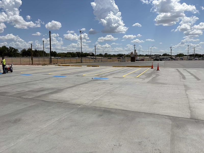 Wide view of a large concrete truck lot paved by Circle H Civil
